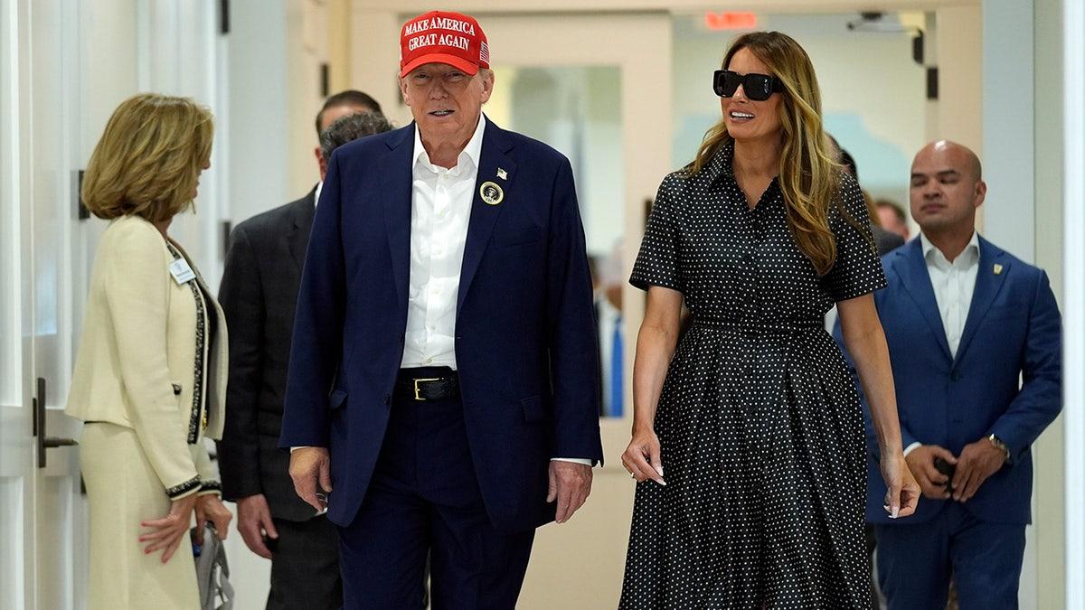 Former President Trump and former first lady Melania Trump walk after voting in Florida after Election Day. (AP/Evan Vuc